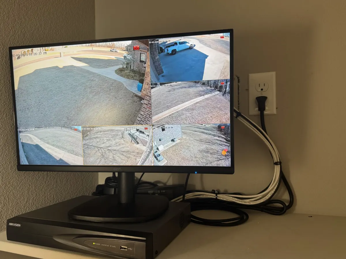 Recorder and monitor showing live camera views at a customer site