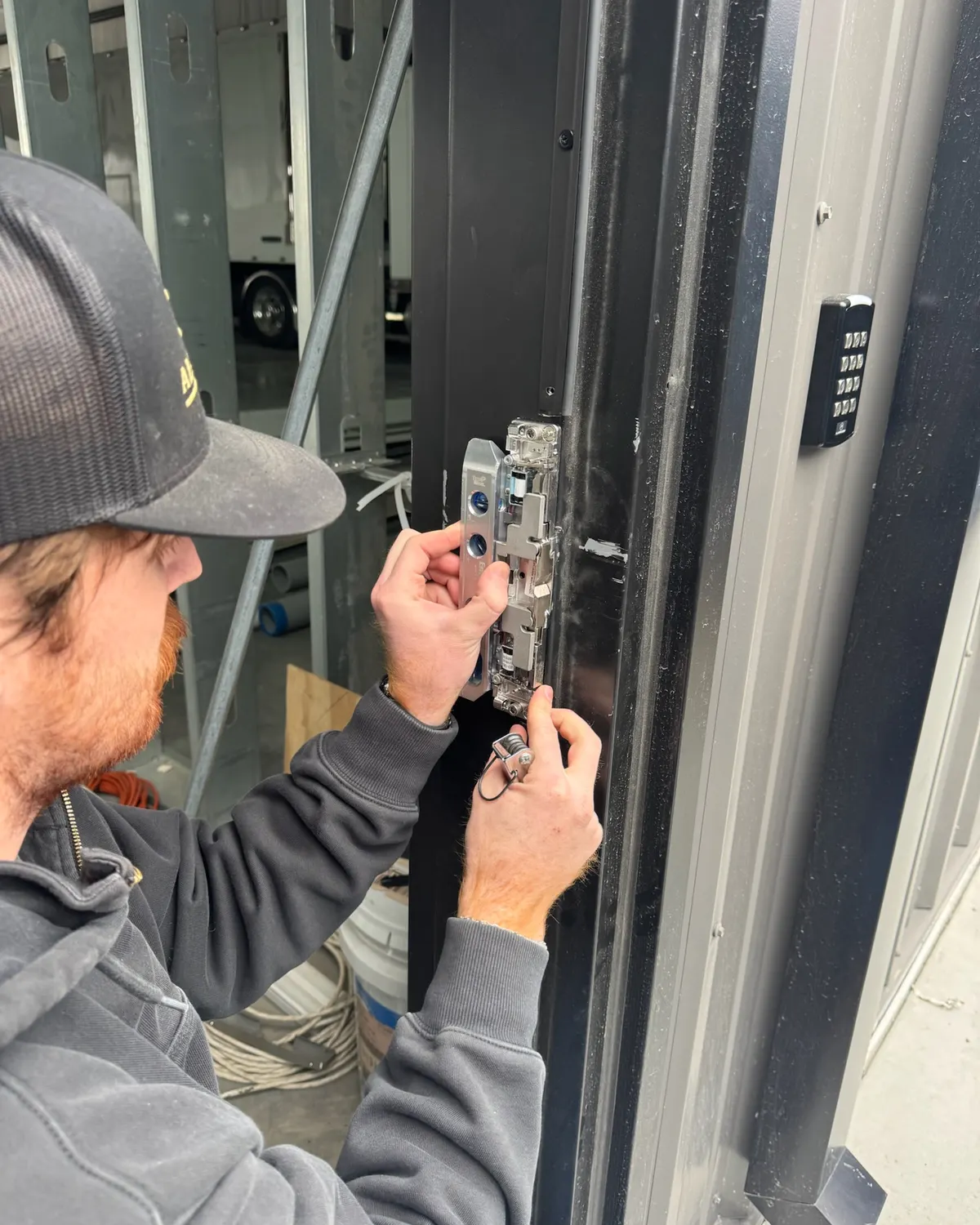 Locksmith fitting an electric strike on a commercial door