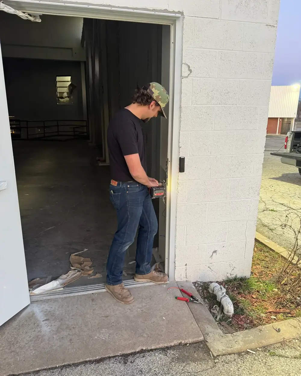 Tulsa Lock & Key technician at a steel door on a commercial building